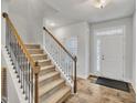 Inviting foyer with hardwood floors, staircase with decorative wrought iron spindles, and natural light at 298 Hannah Yam Ln, Benson, NC 27504
