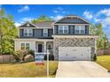 Charming two-story home with stone accents, inviting front porch, and manicured lawn at 298 Hannah Yam Ln, Benson, NC 27504