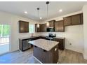 Modern kitchen featuring stainless steel appliances, granite countertops, and a convenient center island at 302 Longbow Dr, Middlesex, NC 27557