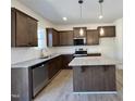 Modern kitchen featuring stainless steel appliances, granite countertops, and a convenient center island at 302 Longbow Dr, Middlesex, NC 27557
