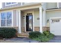 House entrance with a black security door and stone accents at 36 Aster Ln, Pittsboro, NC 27312