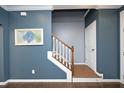 Elegant staircase with white railing and dark hardwood treads at 36 Aster Ln, Pittsboro, NC 27312