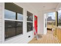 Inviting front porch features wood decking, white railings, and views of the surrounding neighborhood at 825 Graham St, Burlington, NC 27217