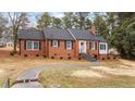 Charming brick ranch home with gray door and stone steps at 103 Park Dr, Oxford, NC 27565