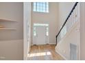 Bright entryway with hardwood floors, staircase, and high ceilings at 106 Dairy Ct, Chapel Hill, NC 27516