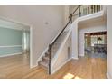 Elegant staircase with dark wood railing and carpeted steps at 106 Dairy Ct, Chapel Hill, NC 27516