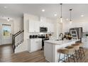 Modern kitchen with white cabinets, island, and stainless steel appliances at 108 Kobus Ct, Garner, NC 27529