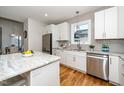 Modern kitchen with white cabinets, granite countertops, and stainless steel appliances at 110 Ethans Glenn Ct, Cary, NC 27513