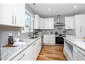 Modern kitchen with white cabinets, granite countertops, and stainless steel appliances at 110 Ethans Glenn Ct, Cary, NC 27513