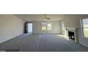 Spacious living room featuring a fireplace, vaulted ceilings and lots of natural light at 120 Magnolia Run Way, Benson, NC 27504