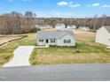 Aerial view of a single-story house with a curved driveway at 120 Starry Sky Dr, Benson, NC 27504
