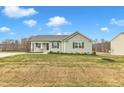 Single-story house with gray siding, a porch, and a driveway at 120 Starry Sky Dr, Benson, NC 27504