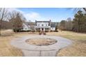 Sprawling estate with circular driveway, beautifully landscaped grounds, and classic two-story white home at 1200 Spring Valley Lake Rd, Henderson, NC 27536
