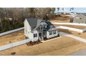 Aerial view of a two-story house featuring a well-manicured lawn and fenced-in yard at 128 S Clearbrook Ct, Angier, NC 27501