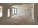Spacious living room featuring large windows, high ceilings, and an open layout at 132 Tennyson Dr, Garner, NC 27529