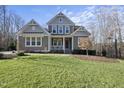 Two-story house with gray siding, white trim, and a front porch at 148 Hidden Creek Ct, Pittsboro, NC 27312