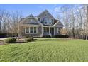 Two-story house with gray siding, white trim, and a front porch at 148 Hidden Creek Ct, Pittsboro, NC 27312