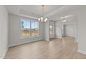 Elegant dining room with hardwood floors and a chandelier at 154 Tennyson Dr, Garner, NC 27529