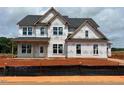 Two-story home with large windows and a classic design, under construction at 154 Tennyson Dr, Garner, NC 27529