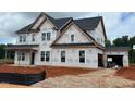 Two-story house featuring a covered porch and an attached garage, under construction at 154 Tennyson Dr, Garner, NC 27529