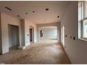 Unfinished living room featuring open archways to other rooms and lots of natural light at 154 Tennyson Dr, Garner, NC 27529
