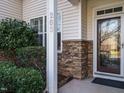 Inviting front entry with stone accents and a glass door at 263 Meadow Beauty Dr, Apex, NC 27539