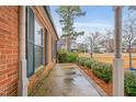 Brick home side porch with concrete flooring at 302 S Pine St, Benson, NC 27504