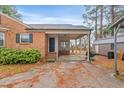 Charming brick home featuring a covered front entrance and well-maintained landscaping at 302 S Pine St, Benson, NC 27504