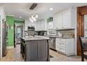 Modern kitchen with granite countertops, an island, and stainless steel appliances at 302 S Pine St, Benson, NC 27504