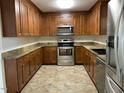 Spacious kitchen with wood cabinets, granite countertops, and stainless steel appliances at 307 Westfield Dr, Dunn, NC 28334