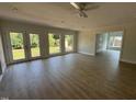 Bright and airy living room with wood flooring, neutral colors, and outdoor access at 307 Westfield Dr, Dunn, NC 28334