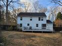 Backyard view of a two-story home with a deck and fenced yard at 4300 Hickory Ridge Dr, Raleigh, NC 27609