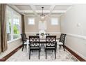 Elegant dining room showcasing coffered ceilings, a chandelier, and a traditional dining set at 4538 Brighton Ridge Dr, Apex, NC 27539