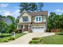 Inviting two-story home featuring a well-maintained lawn and attached garage at 4538 Brighton Ridge Dr, Apex, NC 27539