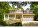 Charming home featuring a welcoming front porch and well-manicured landscaping at 5240 Indigo Moon Way, Raleigh, NC 27613