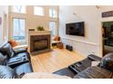 Spacious living room with hardwood floors, fireplace, and large windows at 5240 Indigo Moon Way, Raleigh, NC 27613