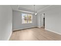 Dining room with light walls, wood-look floors, and a chandelier at 529 Ravensworth Dr, Garner, NC 27529