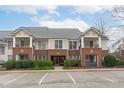 Brick front of a two-story townhome with parking at 105 Fountain Ridge Pl, Holly Springs, NC 27540