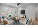 Bright living room with hardwood floors, stylish furnishings, and a ceiling fan at 105 Fountain Ridge Pl, Holly Springs, NC 27540