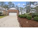 Brick home with attached garage and landscaping at 118 Talon Dr, Cary, NC 27518