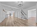Spacious living area with hardwood floors and an open view of the kitchen and staircase at 1200 Rogers Rd, Graham, NC 27253