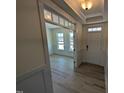 Inviting foyer with hardwood flooring and a view into the adjacent room with natural light at 143 Steppe Way, Garner, NC 27529