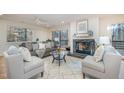 Bright living room featuring a fireplace, comfy seating, and large windows at 2100 Tadley Dr, Chapel Hill, NC 27514