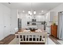 Eat-in kitchen with white cabinets, granite counters, and a center island at 233 John Stark Dr, Fuquay Varina, NC 27526