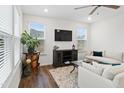 Bright living room with comfy sofas, large TV, and lots of natural light at 233 John Stark Dr, Fuquay Varina, NC 27526