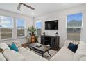 Bright living room with comfy sofas, large TV, and lots of natural light at 233 John Stark Dr, Fuquay Varina, NC 27526