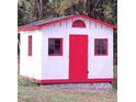 Exterior view of red and white storage shed, offering practicality and charm at 3259 Us 421, Lillington, NC 27546
