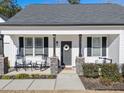 Charming front porch with rocking chairs and stone pillars at 430 Heart Pine Dr, Wendell, NC 27591