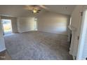 Spacious living room with high ceilings, fireplace, and ceiling fan at 105 Hydrangea Ln, Benson, NC 27504