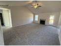 Living room features a fireplace, high ceilings, and access to a deck at 105 Hydrangea Ln, Benson, NC 27504